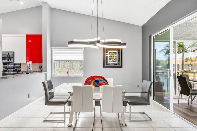 7685 Springwater Pl Unit 201, Boynton Beach, FL 33437 - dining space with light tile patterned flooring, high vaulted ceiling, and baseboards