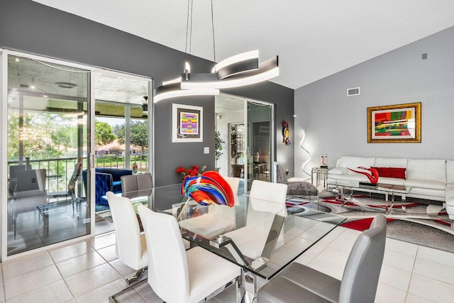 7685 Springwater Pl Unit 201, Boynton Beach, FL 33437 - dining room featuring vaulted ceiling and tile patterned flooring