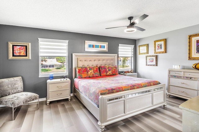7685 Springwater Pl Unit 201, Boynton Beach, FL 33437 - bedroom featuring wood finished floors, a textured ceiling, a ceiling fan, and baseboards