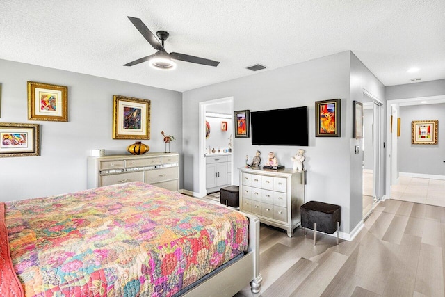 7685 Springwater Pl Unit 201, Boynton Beach, FL 33437 - bedroom with light wood-style floors, a textured ceiling, ensuite bathroom, baseboards, and ceiling fan