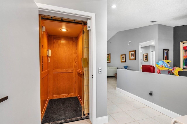 7685 Springwater Pl Unit 201, Boynton Beach, FL 33437 - hall featuring light tile patterned floors, elevator, lofted ceiling, baseboards, and recessed lighting