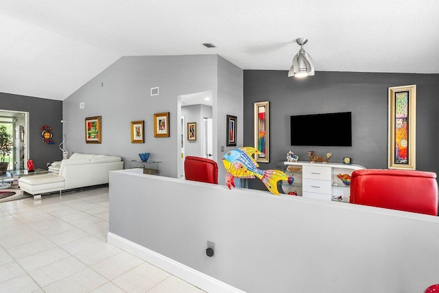 7685 Springwater Pl Unit 201, Boynton Beach, FL 33437 - living area featuring vaulted ceiling, tile patterned floors, and baseboards