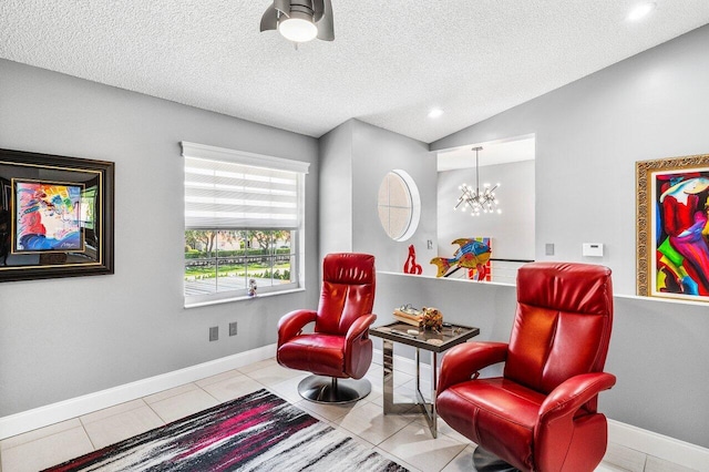 7685 Springwater Pl Unit 201, Boynton Beach, FL 33437 - living area with a chandelier, tile patterned flooring, vaulted ceiling, baseboards, and a textured ceiling