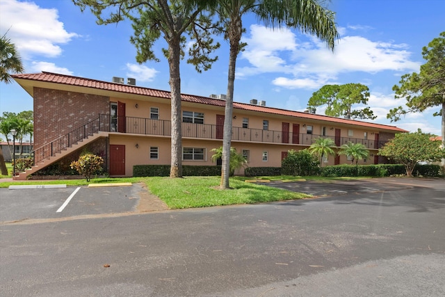 1953 SW Palm City Rd Unit 27-I, Stuart, FL 34994 - view of building exterior featuring uncovered parking and stairway