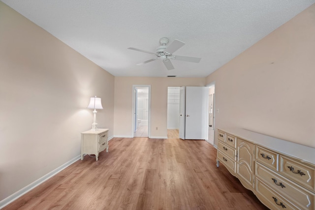 1953 SW Palm City Rd Unit 27-I, Stuart, FL 34994 - unfurnished bedroom with light wood finished floors, baseboards, a spacious closet, and a closet