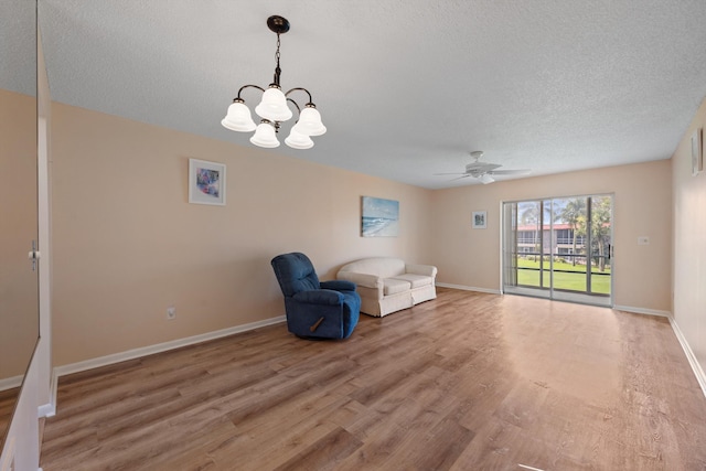 1953 SW Palm City Rd Unit 27-I, Stuart, FL 34994 - unfurnished room with light wood-style flooring, a chandelier, a ceiling fan, a textured ceiling, and baseboards
