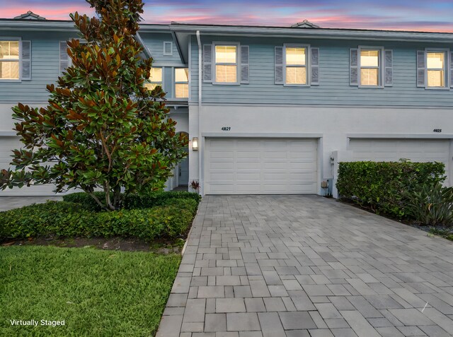 4829 Pointe Midtown Rd Unit 4829, Palm Beach Gardens, FL 33418 - view of property with decorative driveway, an attached garage, and stucco siding