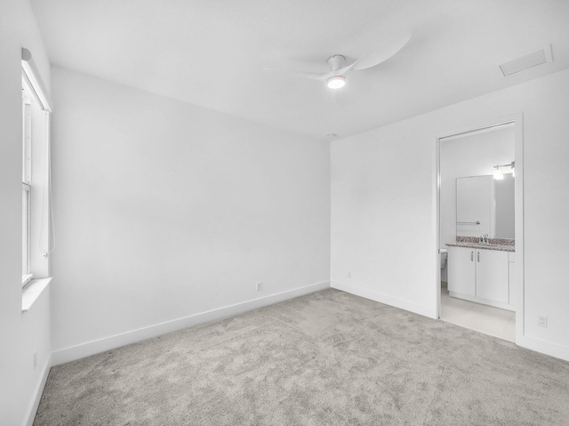 4829 Pointe Midtown Rd Unit 4829, Palm Beach Gardens, FL 33418 - unfurnished bedroom with light carpet, baseboards, a sink, connected bathroom, and a ceiling fan