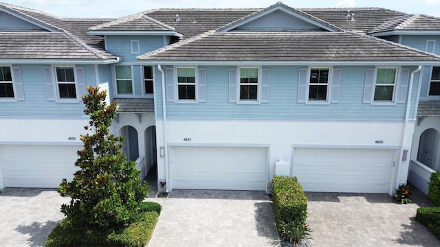4829 Pointe Midtown Rd Unit 4829, Palm Beach Gardens, FL 33418 - traditional-style house with an attached garage, driveway, and stucco siding