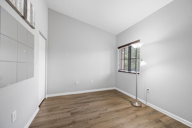 3710 N Jog Rd Unit 202, West Palm Beach, FL 33411 - unfurnished bedroom featuring wood finished floors, baseboards, and lofted ceiling