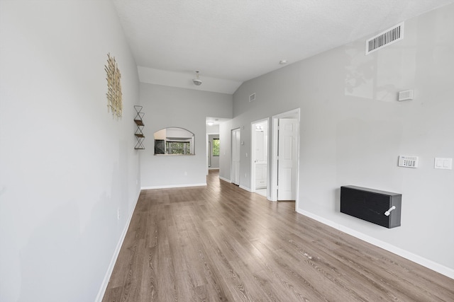 3710 N Jog Rd Unit 202, West Palm Beach, FL 33411 - unfurnished living room with wood finished floors, baseboards, and high vaulted ceiling