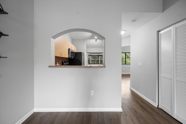 3710 N Jog Rd Unit 202, West Palm Beach, FL 33411 - corridor featuring dark wood finished floors, baseboards, and arched walkways