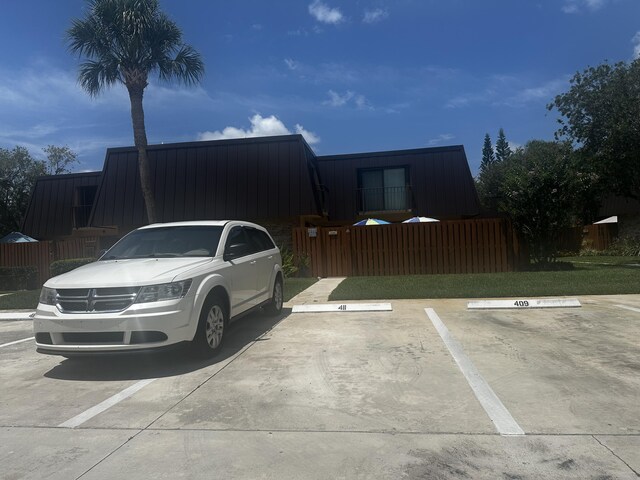 5648 SE Windsong Ln Unit 4-411, Stuart, FL 34997 - view of front of house featuring uncovered parking and metal roof