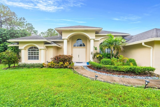 11356 Ira Ln, Lake Worth, FL 33449 - view of front facade featuring stucco siding and a front yard