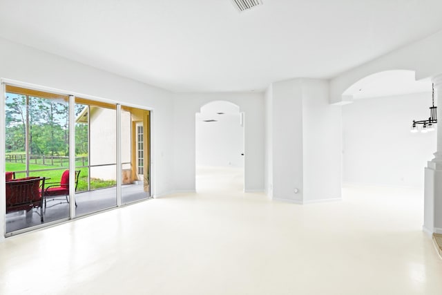 11356 Ira Ln, Lake Worth, FL 33449 - spare room featuring arched walkways and finished concrete floors