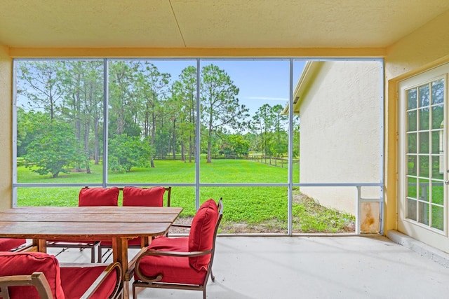 11356 Ira Ln, Lake Worth, FL 33449 - sunroom featuring outdoor dining space, view of scattered trees, and healthy amount of natural light