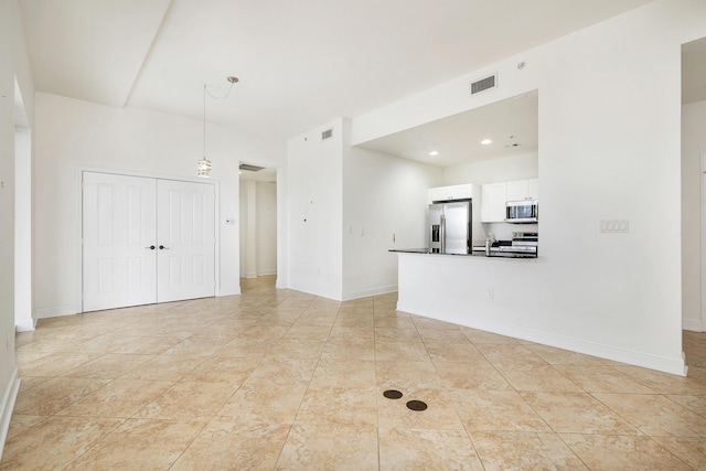 3960 N Flagler Dr Unit 305, West Palm Beach, FL 33407 - unfurnished living room featuring baseboards and a sink