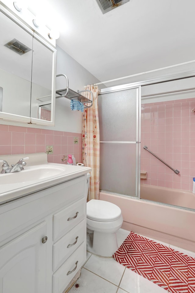 15610 NE 6th Ave NE Unit 10C, Miami, FL 33162 - full bathroom with vanity, combined bath / shower with glass door, tile patterned floors, toilet, and tile walls