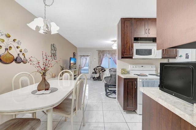 15610 NE 6th Ave NE Unit 10C, Miami, FL 33162 - kitchen featuring white appliances, a chandelier, light countertops, pendant lighting, and dark brown cabinets