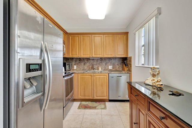 263 Preston Unit G, Boca Raton, FL 33434 - kitchen featuring stainless steel appliances, a sink, backsplash, light tile patterned flooring, and light stone countertops