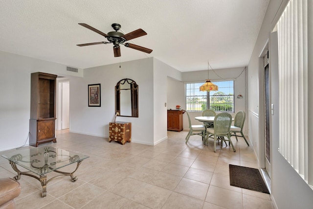263 Preston Unit G, Boca Raton, FL 33434 - living room featuring light tile patterned flooring, ceiling fan, baseboards, and a textured ceiling