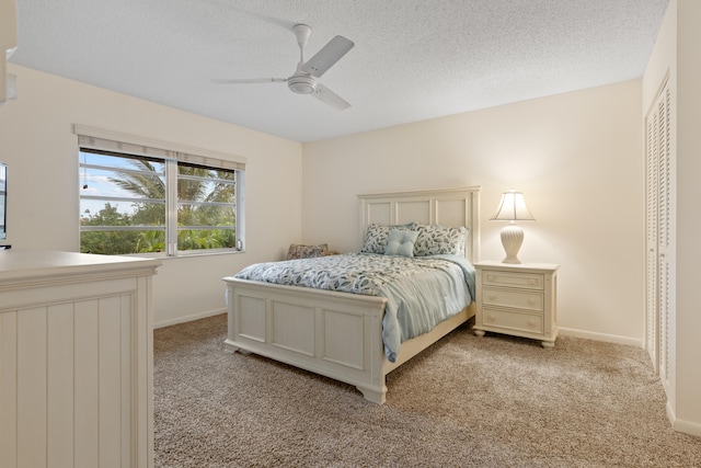 13623 Via Aurora Unit C, Delray Beach, FL 33484 - bedroom featuring light carpet, a ceiling fan, baseboards, and a textured ceiling