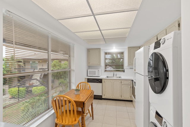 13623 Via Aurora Unit C, Delray Beach, FL 33484 - washroom with estacked washer and dryer and light tile patterned floors