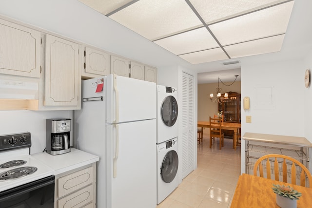 13623 Via Aurora Unit C, Delray Beach, FL 33484 - kitchen featuring range with electric cooktop, stacked washer / dryer, freestanding refrigerator, exhaust hood, and light tile patterned floors