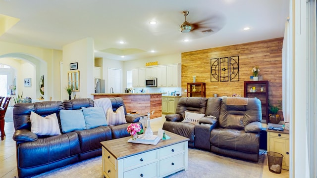 7144 Maidstone Dr, Port Saint Lucie, FL 34986 - living room featuring arched walkways, a ceiling fan, recessed lighting, and wooden walls