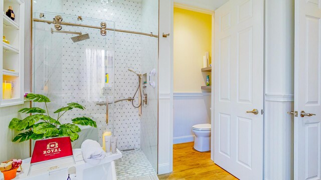 7144 Maidstone Dr, Port Saint Lucie, FL 34986 - bathroom with toilet, a wainscoted wall, wood finished floors, and a walk in shower
