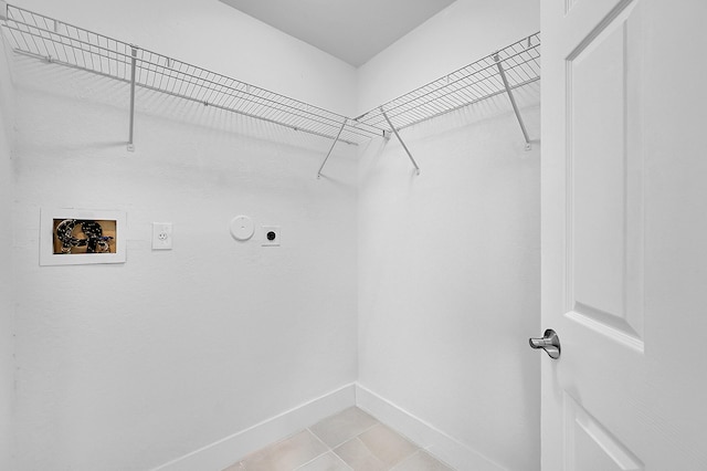 5365 NW 49th St, Coconut Creek, FL 33073 - laundry room featuring electric dryer hookup, hookup for a washing machine, baseboards, and light tile patterned floors