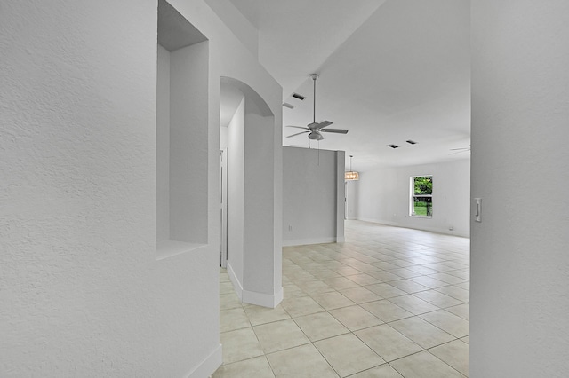 5365 NW 49th St, Coconut Creek, FL 33073 - unfurnished room featuring arched walkways, ceiling fan, light tile patterned floors, a textured wall, and baseboards