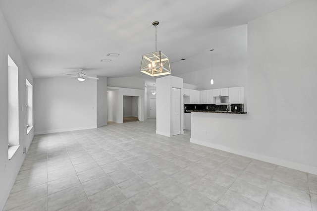 5365 NW 49th St, Coconut Creek, FL 33073 - unfurnished living room featuring ceiling fan, vaulted ceiling, a chandelier, light tile patterned floors, and baseboards