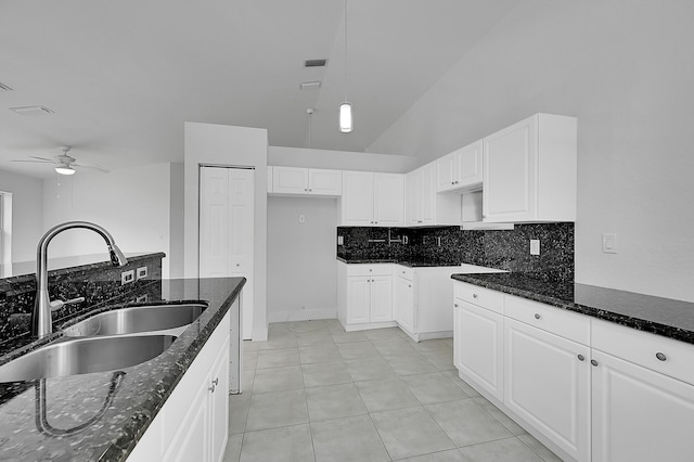 5365 NW 49th St, Coconut Creek, FL 33073 - kitchen featuring a sink, dark stone countertops, a ceiling fan, tasteful backsplash, and white cabinets