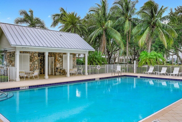 1463 N Jeaga Dr, Jupiter, FL 33458 - community pool featuring a patio and an outbuilding