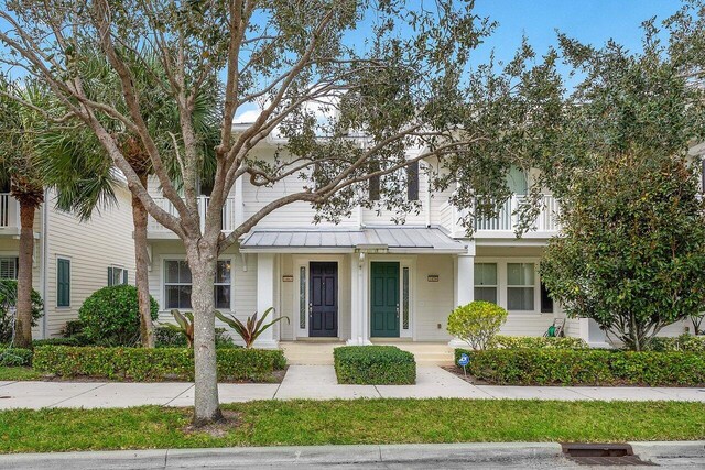1463 N Jeaga Dr, Jupiter, FL 33458 - view of property with a standing seam roof and metal roof