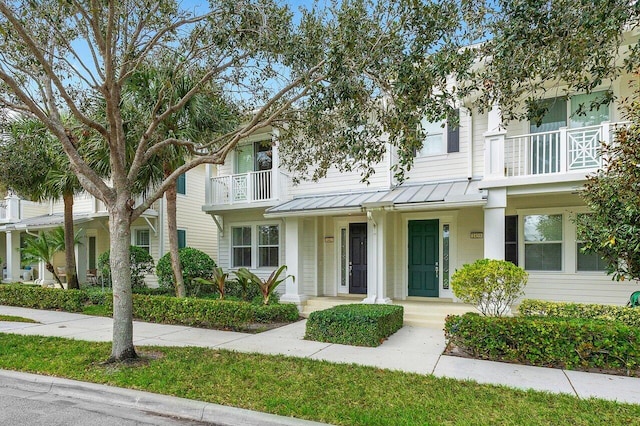 1463 N Jeaga Dr, Jupiter, FL 33458 - multi unit property with a standing seam roof, metal roof, a balcony, and covered porch