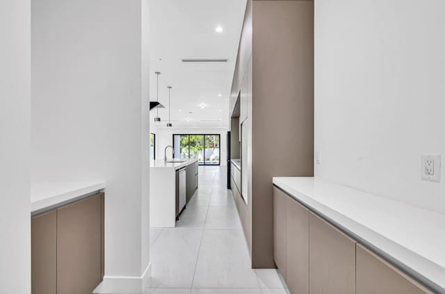1233 NE 12th Ave Unit A, Fort Lauderdale, FL 33304 - hallway with light tile patterned floors, recessed lighting, and a sink