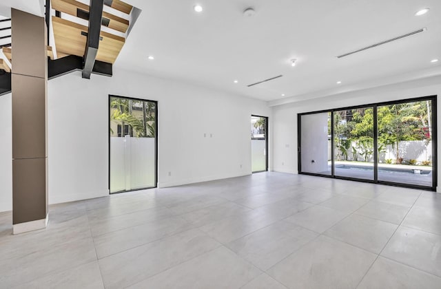 1233 NE 12th Ave Unit A, Fort Lauderdale, FL 33304 - empty room featuring plenty of natural light, light tile patterned floors, recessed lighting, and a smoke detector