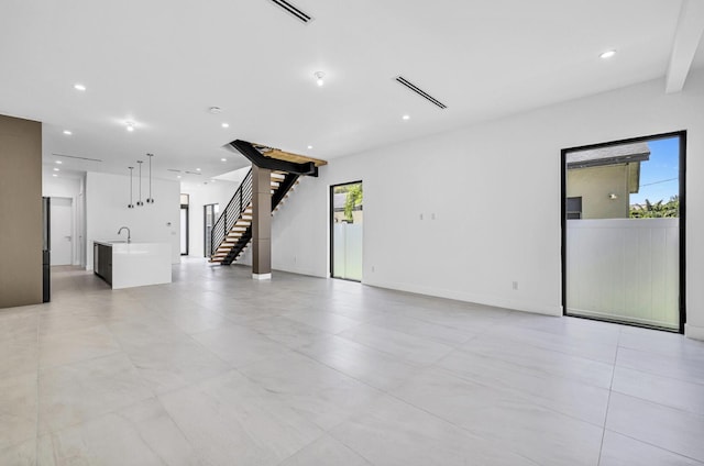 1233 NE 12th Ave Unit A, Fort Lauderdale, FL 33304 - unfurnished living room with a sink, stairway, and recessed lighting
