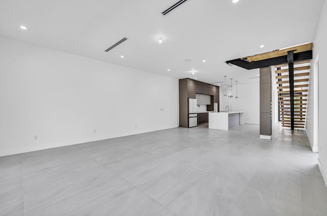 1233 NE 12th Ave Unit A, Fort Lauderdale, FL 33304 - unfurnished living room featuring recessed lighting, baseboards, and a sink