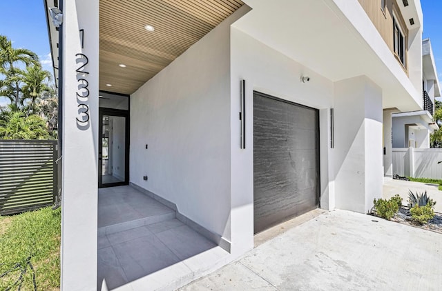 1233 NE 12th Ave Unit A, Fort Lauderdale, FL 33304 - property entrance featuring a garage and stucco siding