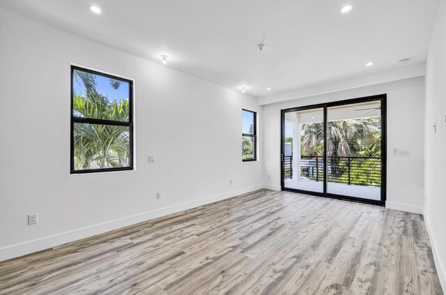1233 NE 12th Ave Unit A, Fort Lauderdale, FL 33304 - empty room with light wood finished floors, recessed lighting, and baseboards