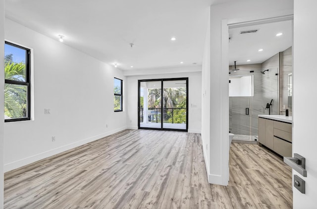1233 NE 12th Ave Unit A, Fort Lauderdale, FL 33304 - unfurnished living room featuring light wood-style flooring, recessed lighting, and baseboards