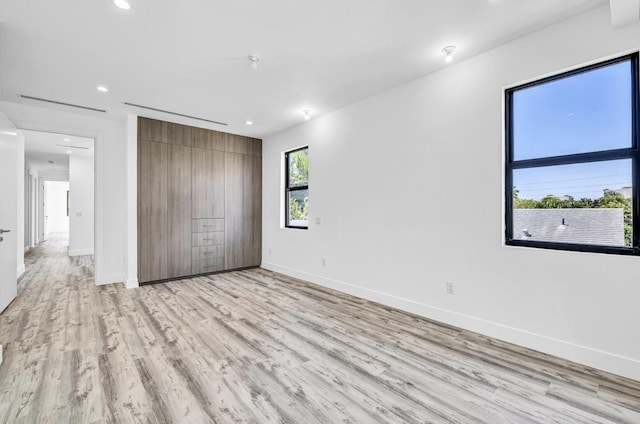 1233 NE 12th Ave Unit A, Fort Lauderdale, FL 33304 - unfurnished bedroom featuring light wood-style flooring, baseboards, and recessed lighting