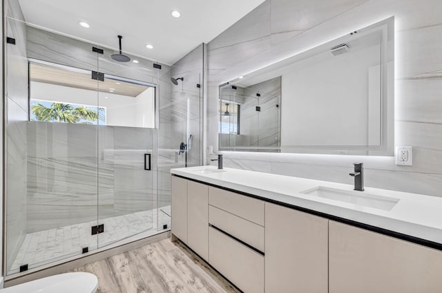1233 NE 12th Ave Unit A, Fort Lauderdale, FL 33304 - bathroom with double vanity, a shower stall, recessed lighting, and wood finished floors