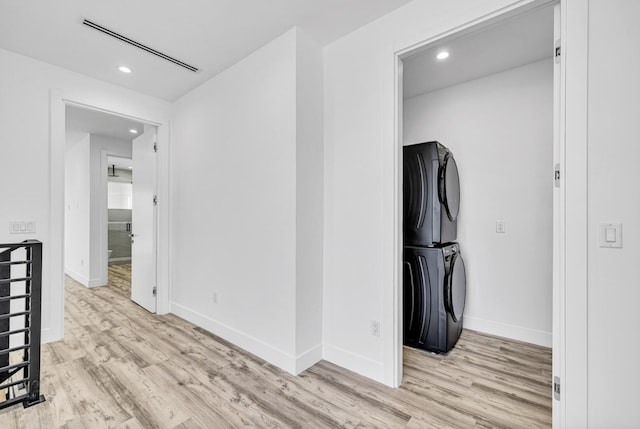1233 NE 12th Ave Unit A, Fort Lauderdale, FL 33304 - hallway with stacked washing machine and dryer, light wood finished floors, recessed lighting, and baseboards