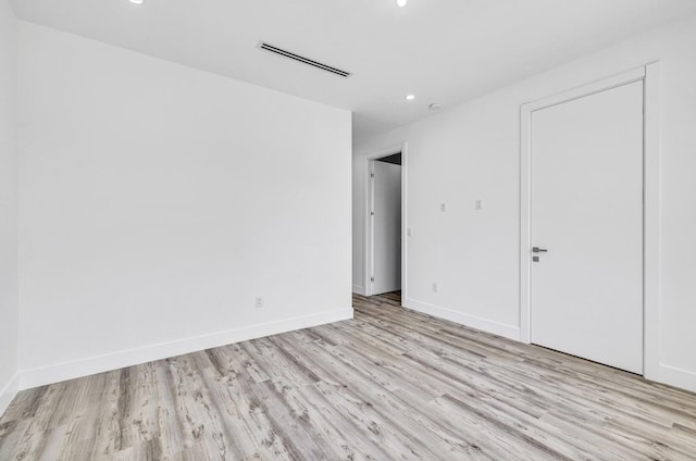 1233 NE 12th Ave Unit A, Fort Lauderdale, FL 33304 - unfurnished bedroom with wood finished floors, recessed lighting, and baseboards