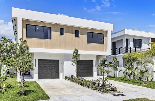 1233 NE 12th Ave Unit A, Fort Lauderdale, FL 33304 - contemporary house with a garage, concrete driveway, and stucco siding