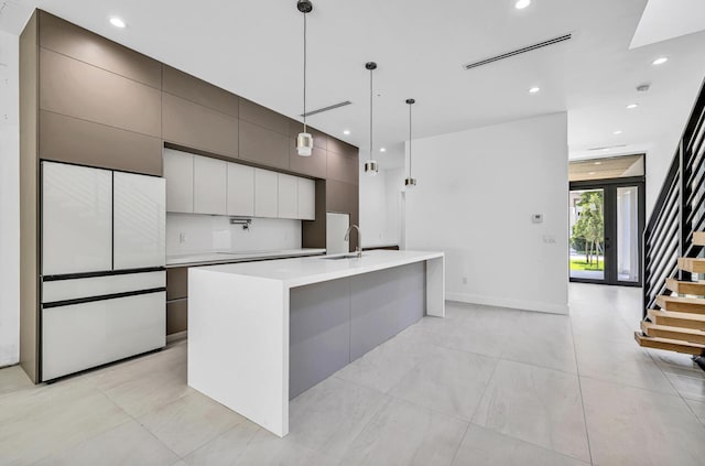 1233 NE 12th Ave Unit A, Fort Lauderdale, FL 33304 - kitchen with modern cabinets, a sink, light countertops, freestanding refrigerator, and recessed lighting